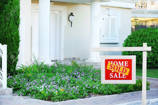 Real estate sign in front of new house. Sold home for sale