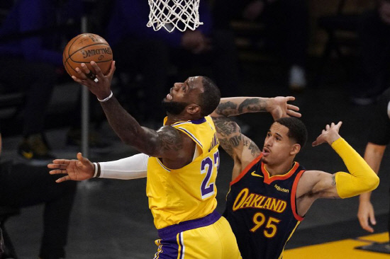 LeBron James, left, shoots