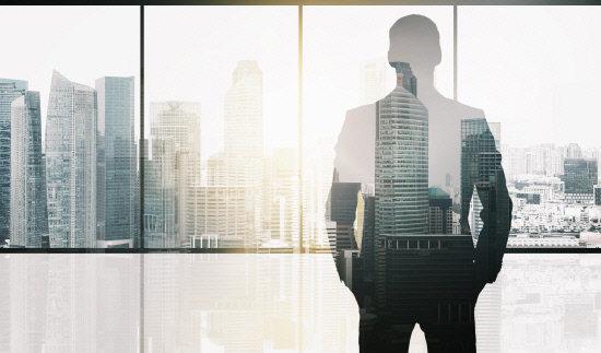 silhouette of business man over office background