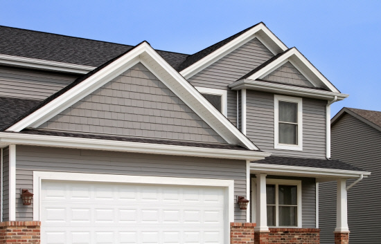 New home with vinyl siding, gutters, roof