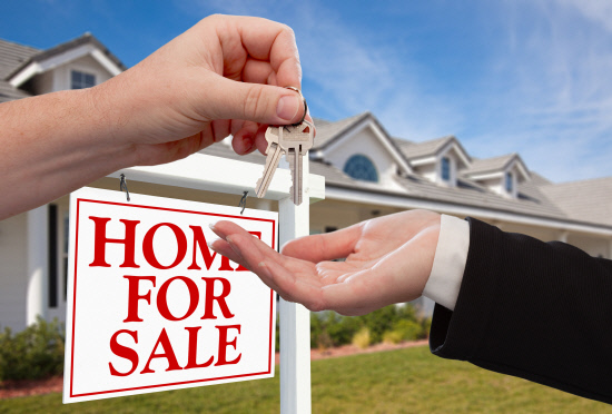 Handing Over the House Keys in Front of New Home