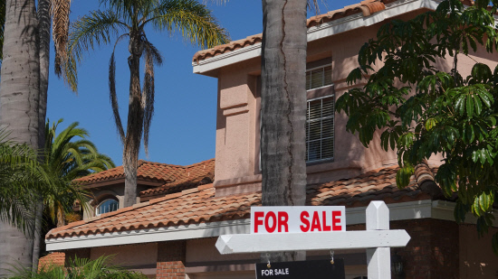 For sale sign on suburban home