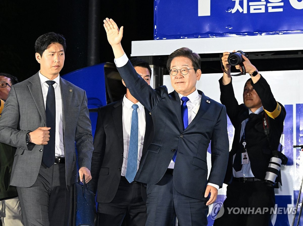 제21대 대통령 당선이 확실시되는 더불어민주당 이재명 대선 후보가 4일 서울 여의도 국회 인근에서 당 주최로 열린 국민개표방송 행사에 참석해 시민들을 향해 인사하고 있다.(연합)