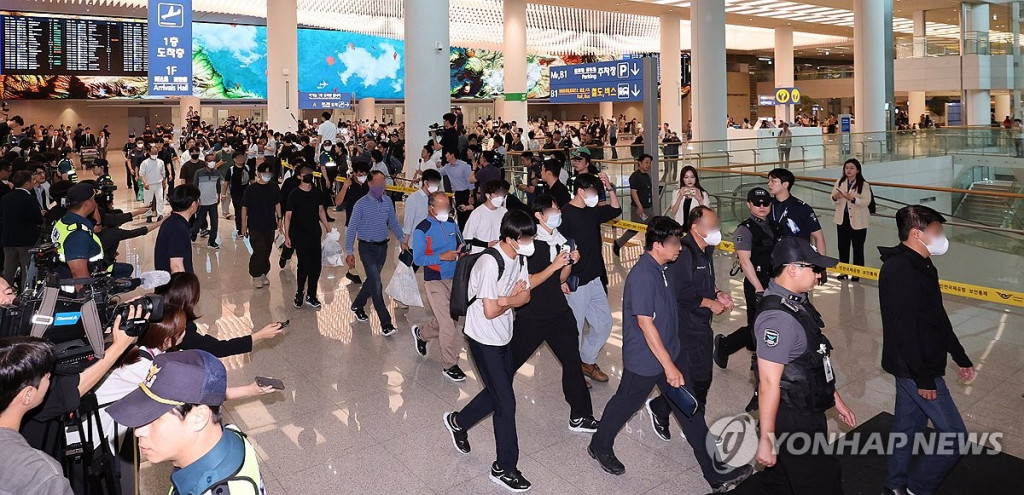 미국 이민당국에 의해 조지아주에 구금됐던 한국인 근로자들이 12일 영종도 인천국제공항 제2여객터미널 입국장을 나서고 있다. (연합)