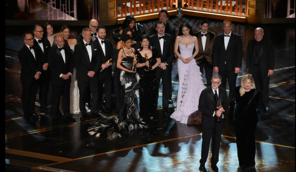 15일(현지시간) 로스앤젤레스 돌비극장에서 열린 98회 아카데미 시상식에서 작품삭 등 6개부문에서 수상한 '원배틀 애프터 어나더' 출연자와 제작진이 함께 무대에 올라 폴 토마스 앤더슨 감독(앞 왼쪽)과 공동제작자 사라 머피의 소감을 듣고 있다.[AP=연합] 